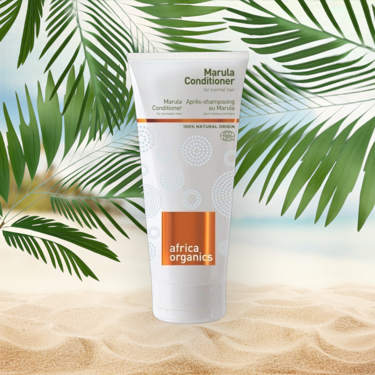 En tube Africa Organics Marula balsam 200ml på en strand med palmer i baggrunden, der fremmer velvære og helbred.