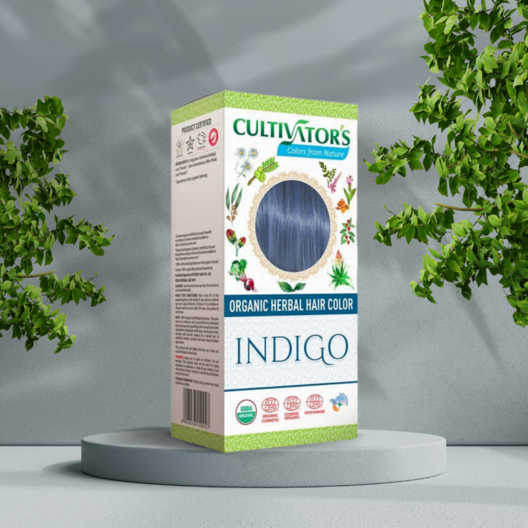 En æske Cultivators Indigo 100g hår foran et velvære træ.