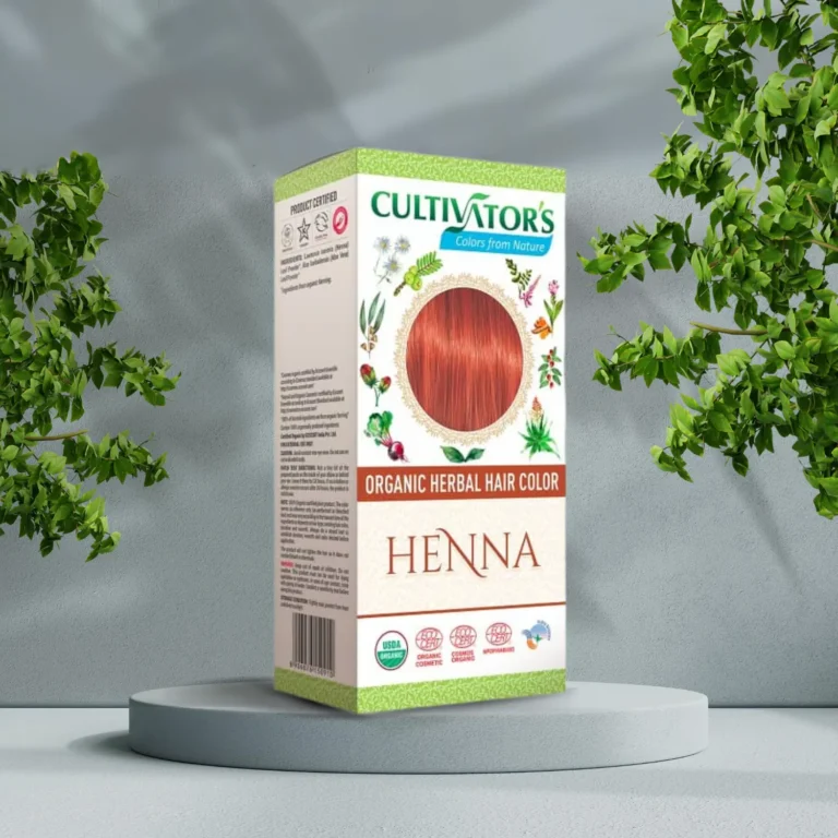 En æske Cultivators Henna 100g hårfarve foran et træ.