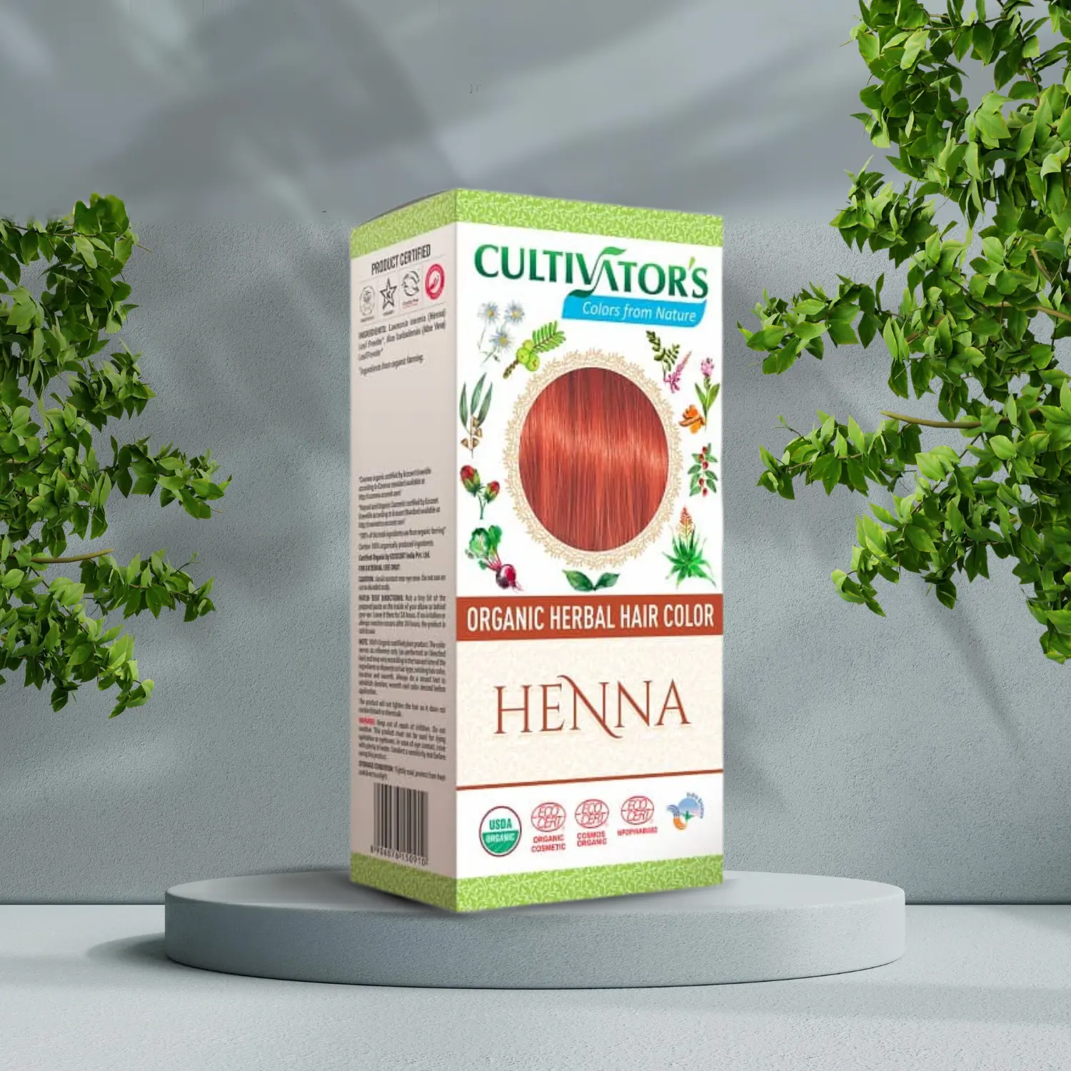 En æske Cultivators Henna 100g hårfarve foran et træ.